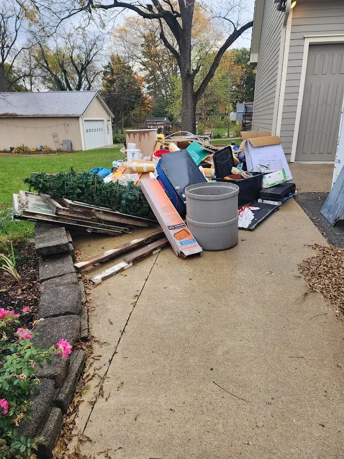 Dumpster being loaded with debris for 12 Yard Dumpster Rental in Fruit Heights